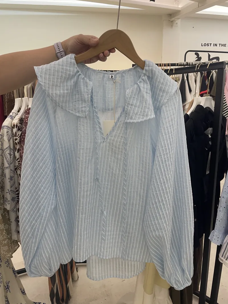Blue Stripe Ruffle-Collar Sleeveless Blouse — Tops & Tees by NEWCOM women's wear manufacturer