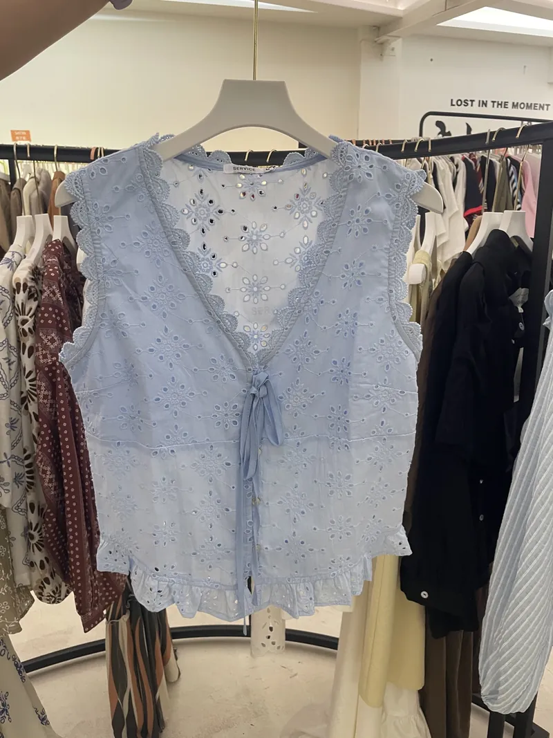 Blue Eyelet Tie-Front Sleeveless Blouse — Tops & Tees by NEWCOM women's wear manufacturer